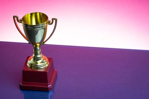 Trophy on the red background. Selective focus 库存照片