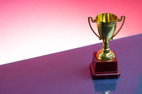 Trophy on the red background. Selective focus Photos