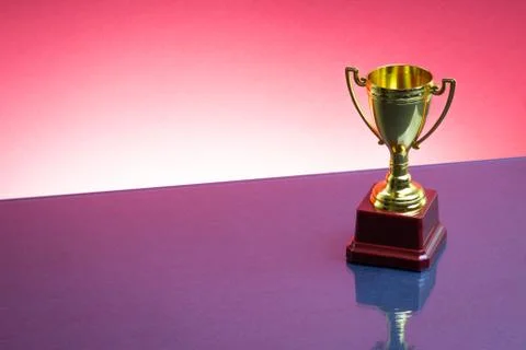 Trophy on the red background. Selective focus 库存照片