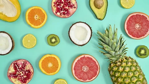 Tropic summer pattern with exotic fruits on cyan background. Stop motion Stock Footage 201694694