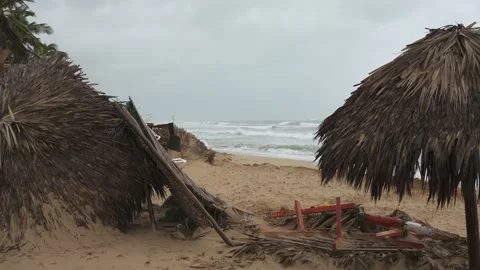 Tropical beach after storm. Fallen parasol made of palm leaves in windy weather Stock Footage 220038959