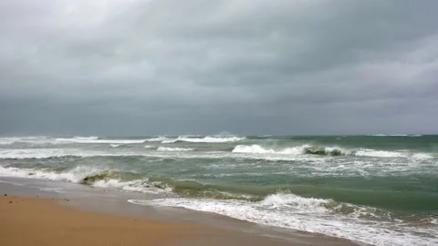 Tropical beach after storm. Waves are crashing to the coast. Seashore after Stock Footage 220039242