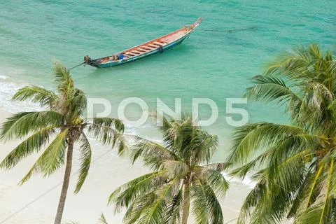 Tropical beach and rowboat Stock Photos