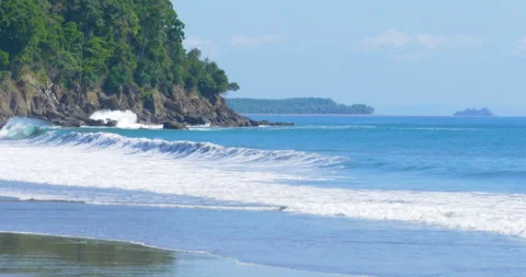 Tropical Beach And Waves Come To Shore And Hit Volcanic Hilly Jungle Coastline Stock Footage 137905559