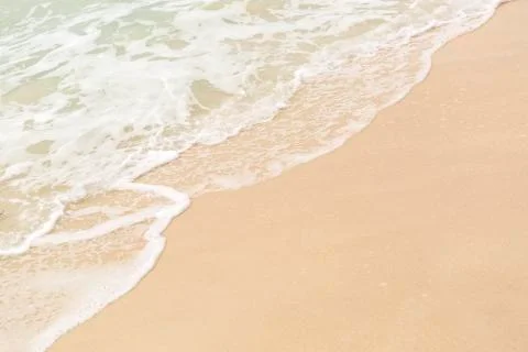Tropical beach background with soft wave and sand Stock Photos