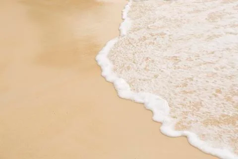Tropical beach background with soft wave and sand Stock Photos