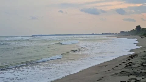 A tropical beach with big waves and wide area of sand Stock Footage 279489780