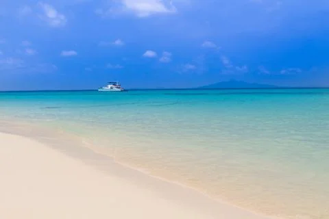 Tropical beach with clouds Stock Photos
