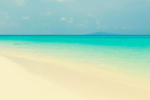 Tropical beach with clouds Stock Photos