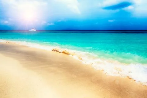 Tropical beach with clouds Stock Photos