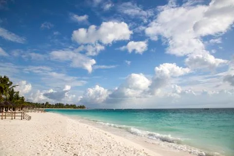 Tropical beach with clouds Stock Photos