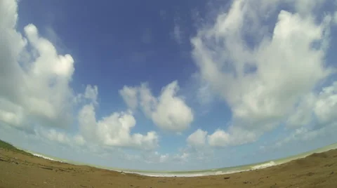 Tropical beach with clouds running through blue sky. 4K time lapse. Stock Footage 42523382