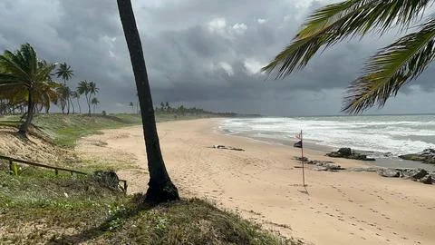 Tropical beach on a cloudy day Stock Photos