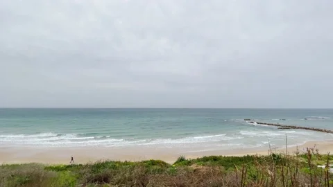 Tropical beach on a cloudy day, small waves on the ocean with clouds Stock Footage 146584064