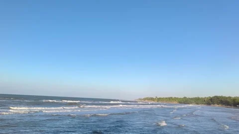 Tropical Beach Coastline With Rolling Ocean Waves and Clear Blue Sky Stock Footage 340338355