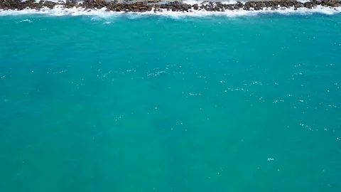 Tropical beach with colorful umbrellas - Top down aerial view Stock Footage