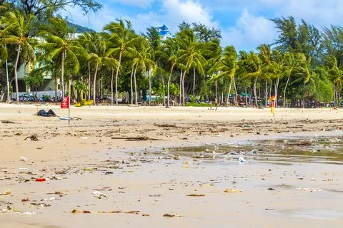 Tropical beach disaster with floating plastic waste and disgusting polluted.. Stock Photos