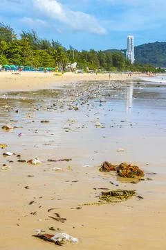 Tropical beach disaster with floating plastic waste and disgusting polluted.. Stock Photos
