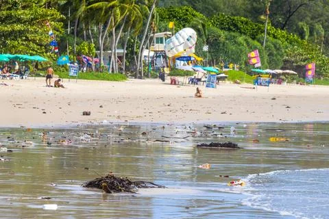 Tropical beach disaster with floating plastic waste and disgusting polluted.. Stock Photos