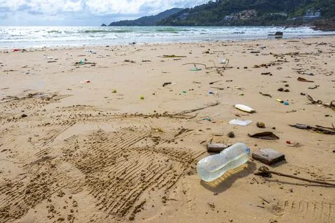 Tropical beach disaster with floating plastic waste and disgusting polluted.. Stock Photos