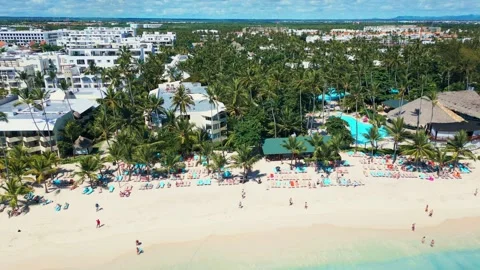 A tropical beach full of tourists in Punta Cana - Aerial view Stock Footage 309028279