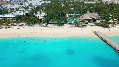A tropical beach full of tourists in Punta Cana - Aerial view Stock Footage 309028361