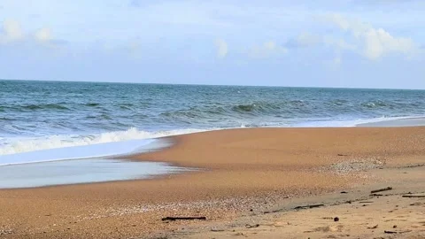 Tropical Beach with Gentle Ocean Waves and Soft Clouds in Peaceful Sky Stock Footage 319905994