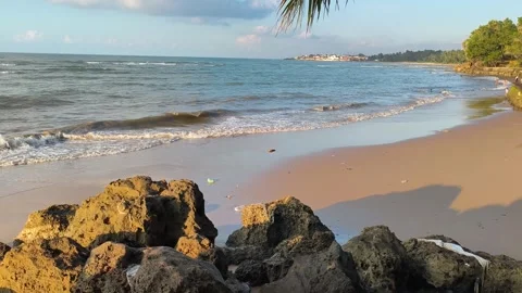 Tropical Beach Landscape with Waves and Rocky Shore at Golden Hour Stock Footage 340489587