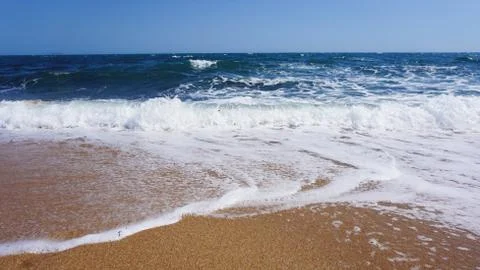 Tropical beach. Ocean wave background. Sand and blue sea. Summer sea vacation Stock Photos