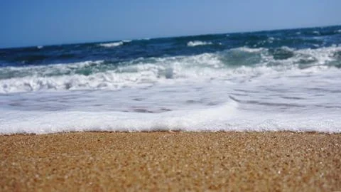 Tropical beach. Ocean wave background. Sand and blue sea. Summer sea vacation Stock Photos