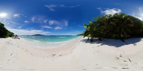 Tropical beach with palm trees and turquoise waters. La Digue, Seychelles. Stock Footage 301446789