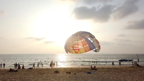 Tropical beach with parasails installed on shore on a sunny day. Video stock 129836656
