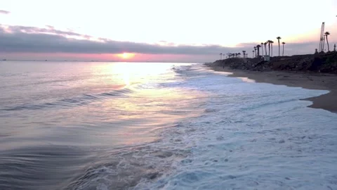 Tropical Beach, Sun Setting on Horizon Above Tropical Beach Waves Crashing on Stock-Footage 332677804