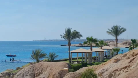 Tropical beach with sun umbrellas on the Red Sea near the coral reef, Panoramic 動画素材 237450074