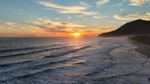 Tropical Beach Sunset with Ocean Waves and Mountain Silhouette Stock Footage 340528614