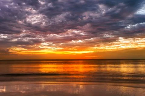 Tropical beach at sunset. Stock Photos