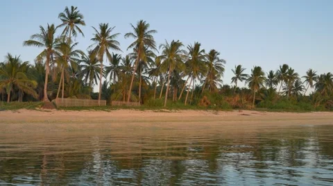 Tropical beach at sunset in UHD Stockbeeldmateriaal 61678730