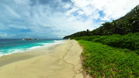 Tropical beach with turquoise ocean and lush green vegetation. Seychelles, Mahe. Stock Footage 342643250