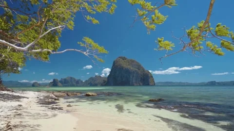 Tropical beach view with crystal-clear water, a white sandy shore, and lush.. Stock Footage 304113272