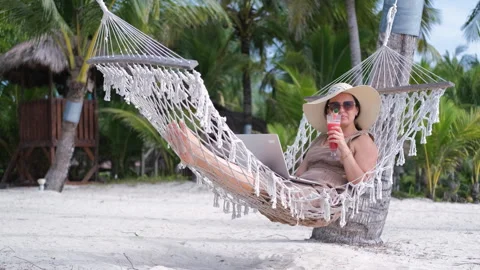 Tropical beach work in hammock with fruit shake Stock Footage 312381233