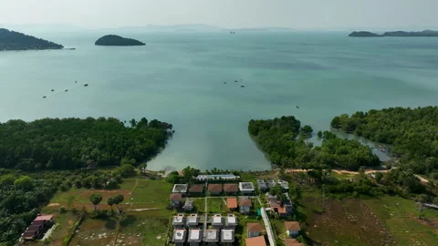 Tropical beachfront villas overlooking a turquoise bay Stock Footage 303358695