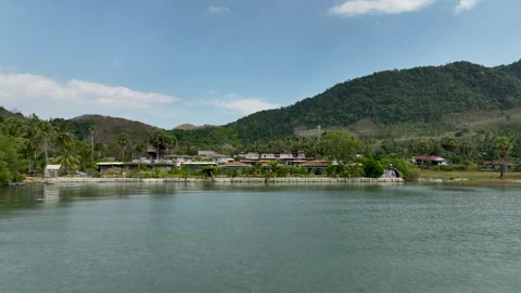 Tropical beachfront villas overlooking a turquoise bay Video stock 303372477
