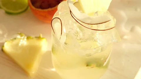 Tropical blended fruit smoothies. Pineapple, orange, coconut, lime, mint, ice Stock Footage 130743864