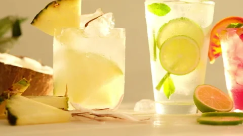 Tropical blended fruit smoothies. Pineapple, orange, coconut, lime, mint, ice Stock Footage 130744106