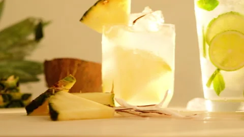 Tropical blended fruit smoothies. Pineapple, orange, coconut, lime, mint, ice Stock Footage 130744124