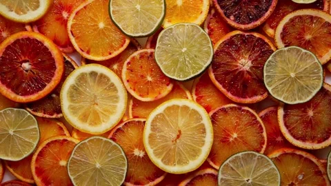 Tropical Citrus Slice Delight: Fruit Background with Oranges, Lemons, and Limes Stock Footage 241570083