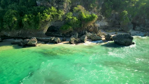 Tropical cliffs and emerald waves at Padang Padang Beach, Bali drone footage Stock Footage 320071323