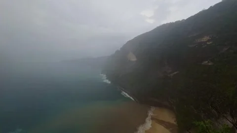 Tropical coastline with high cliff, beach, and ocean water Vídeos de archivo 340847564