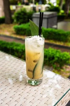 Tropical cocktail served in a refreshing glass with straw and ice, placed on  Stock Photos