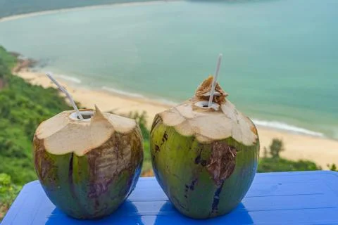 Tropical coconuts on the table by the beach Stock Photos